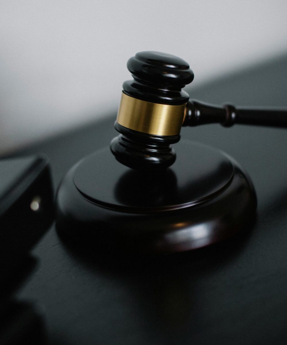 Close-up of a wooden gavel on a desk, symbolizing justice and legal authority.